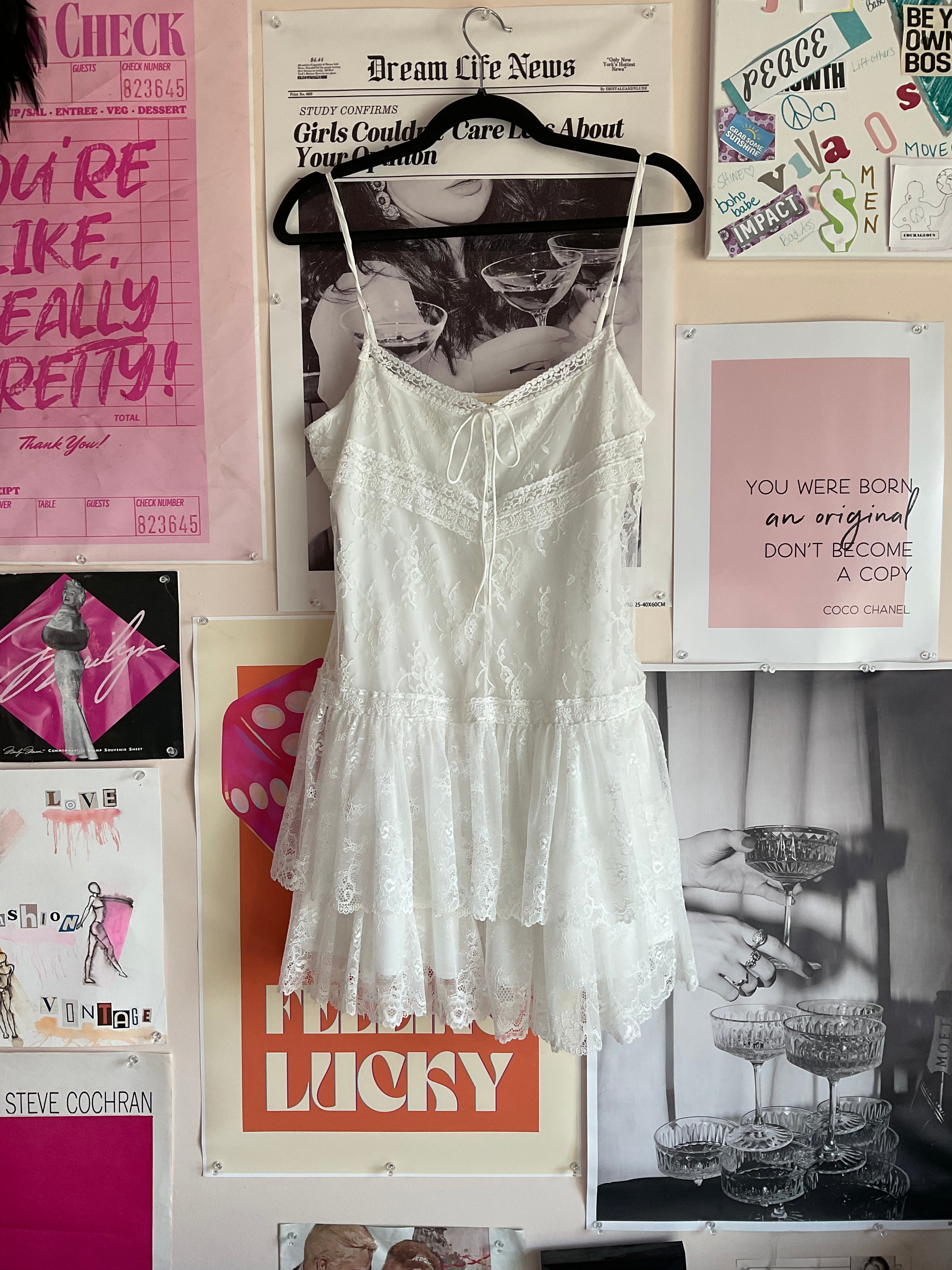 White lace mini dress with tiered ruffled skirt