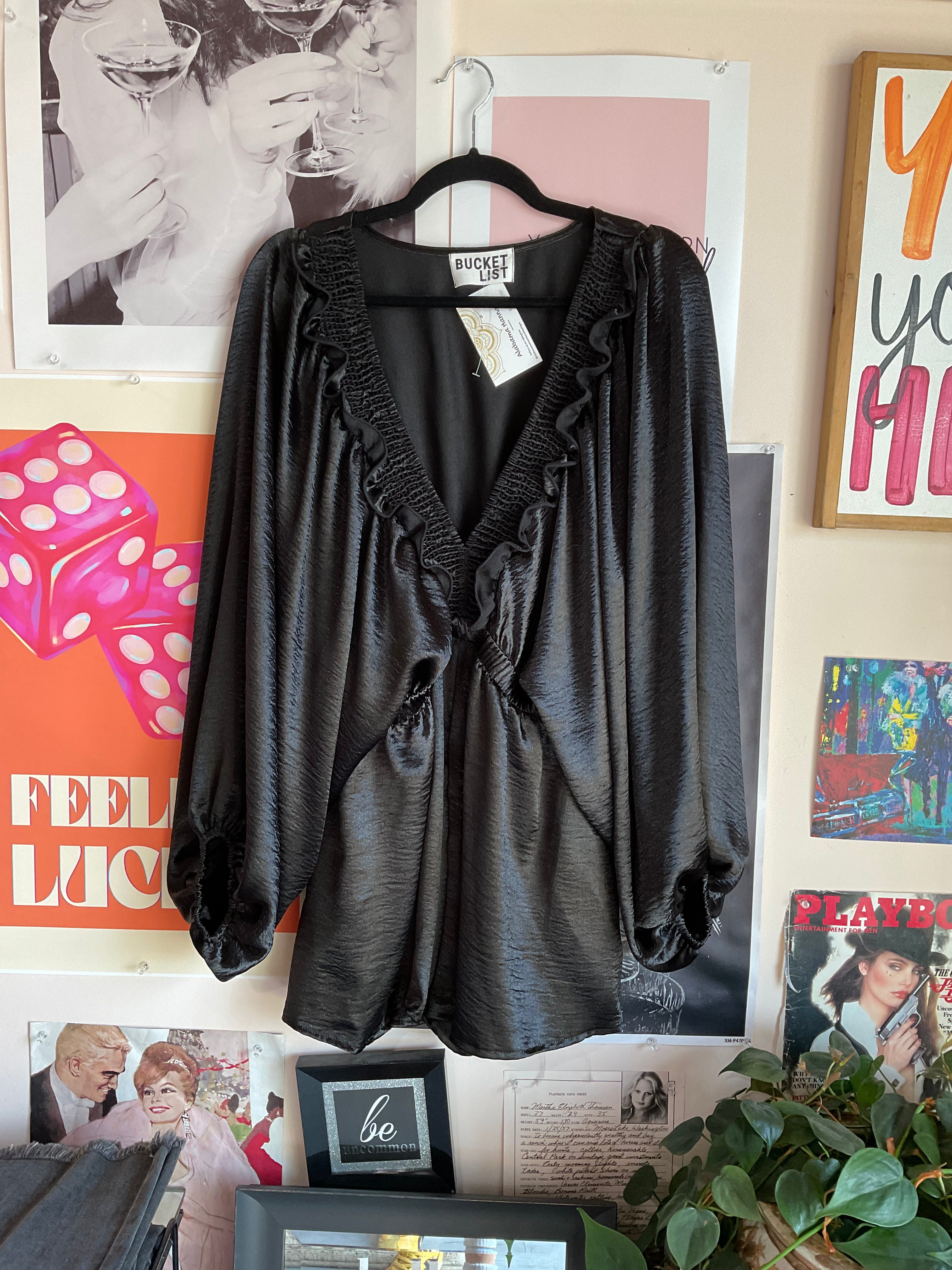Black long sleeve v-neck romper with ruffled trim