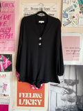 Black long sleeve button-front romper